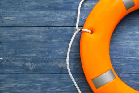 Lifebuoy ring on wooden background