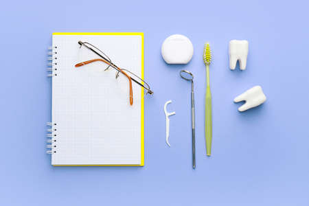 Set for oral hygiene with notebook and eyeglasses on color backgroundの写真素材