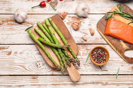Asparagus with salmon, vegetables and spices on tableの写真素材