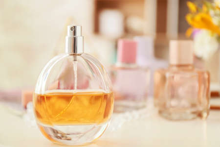 Perfume and cosmetics on table