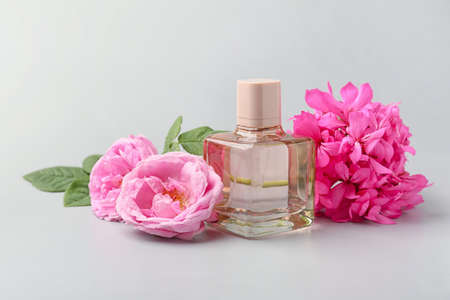 Bottle of floral perfume on gray background