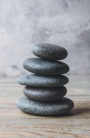 Stack of spa stones on gray backgroundの写真素材