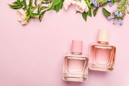 Bottles of floral perfume on color backgroundの写真素材
