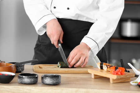 Handsome Asian chef cooking in kitchen, closeupの写真素材