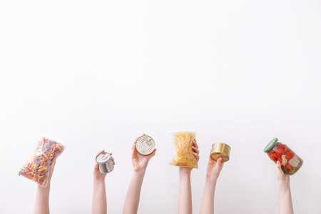 Hands with products on light background. Concept of donationsの写真素材