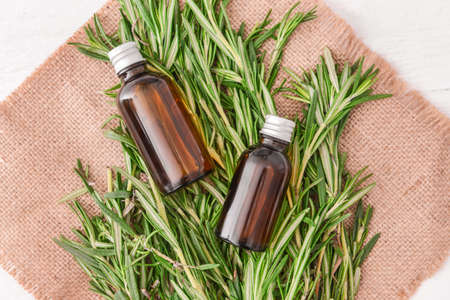 Bottles of rosemary essential oil on tableの写真素材