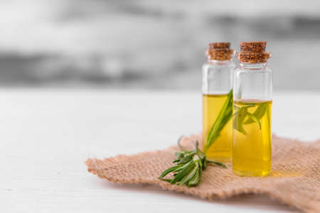 Bottles of rosemary essential oil on tableの写真素材