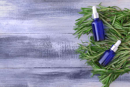 Bottles of rosemary essential oil on tableの写真素材