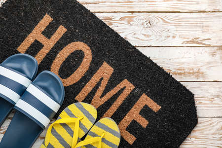 Door mat and shoes on floorの写真素材