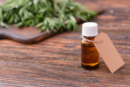 Bottle of rosemary essential oil on tableの写真素材