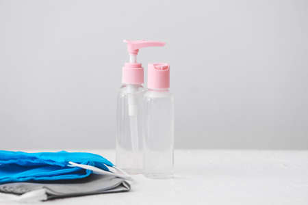 Disinfectants and medical masks on tableの写真素材