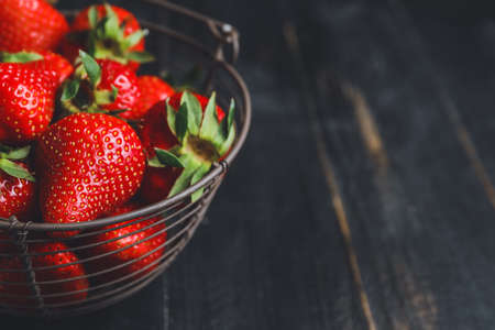 Basket with ripe strawberry on dark background, closeupの写真素材