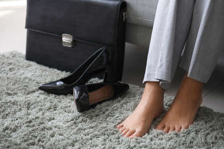 Businesswoman relaxing after work at homeの写真素材