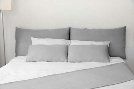 Big comfortable bed in hotel roomの写真素材