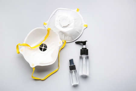 Disinfectants and medical masks on light backgroundの写真素材