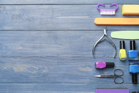 Supplies for manicure on wooden background