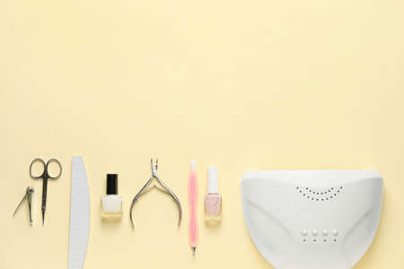 Supplies for manicure on color background