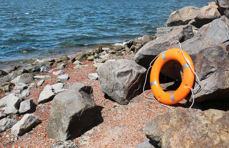 Bright lifebuoy ring on coastの写真素材