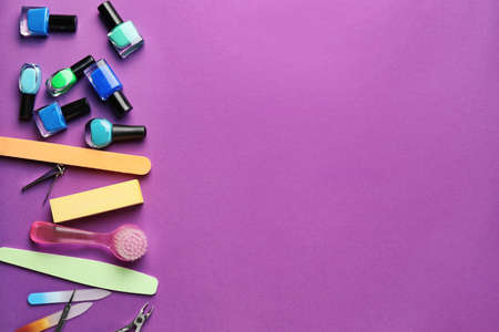 Supplies for manicure on color background