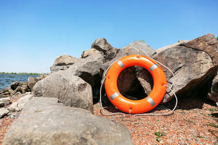 Bright lifebuoy ring on coastの写真素材