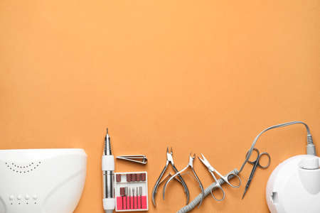 Supplies for manicure on color background