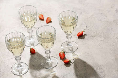 Glasses of tasty champagne and strawberry on table