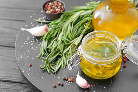 Rosemary oil and spices on tableの写真素材