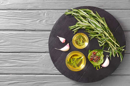Rosemary oil and spices on tableの写真素材
