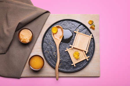 Tasty dandelion honey on color background