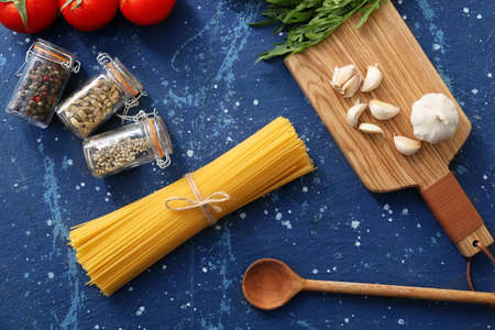 Dry pasta with products on color backgroundの写真素材
