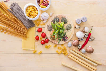 Dry pasta with products on table