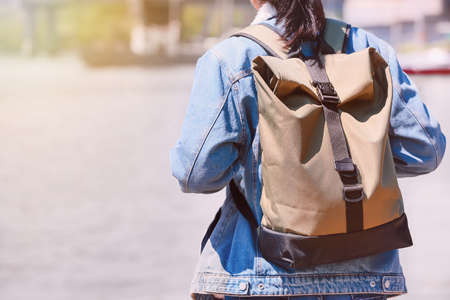 Female traveler with backpack near riverの写真素材