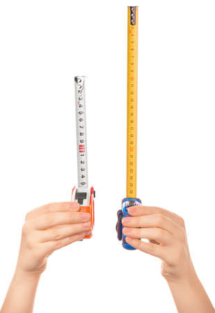 Female hands with measuring tapes on white backgroundの写真素材