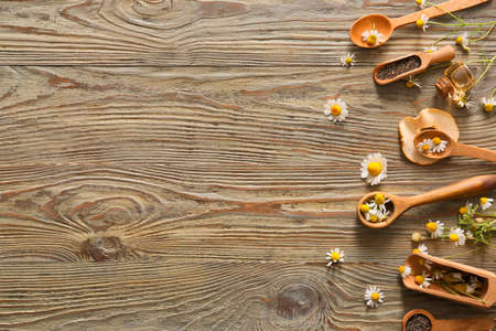 Composition with chamomile flowers on wooden backgroundの写真素材