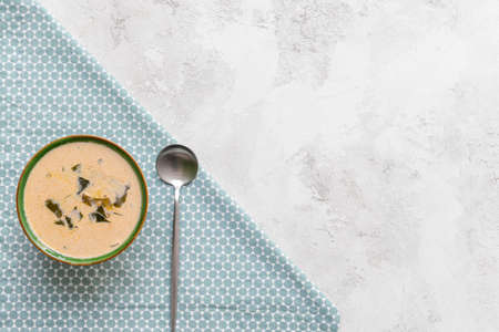 Bowl with tasty seaweed soup on light backgroundの写真素材