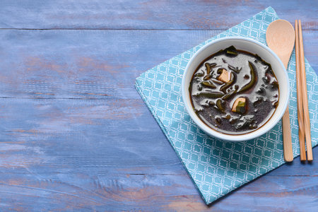 Bowl with tasty seaweed soup on tableの写真素材