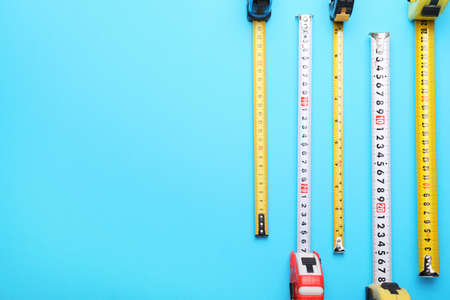 Measuring tapes on color background
