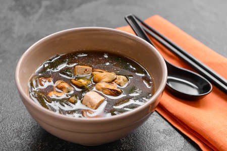 Bowl with tasty seaweed soup on dark backgroundの写真素材