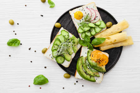 Plate with tasty avocado sandwiches on table