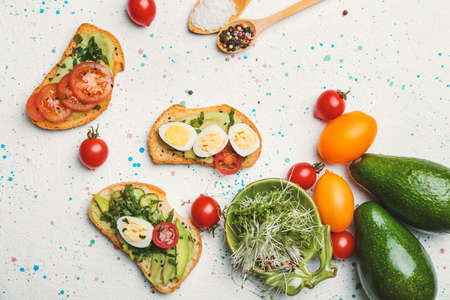 Tasty avocado sandwiches on white backgroundの写真素材