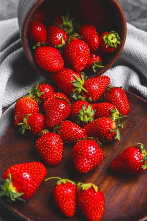 Sweet ripe strawberry scattered on table