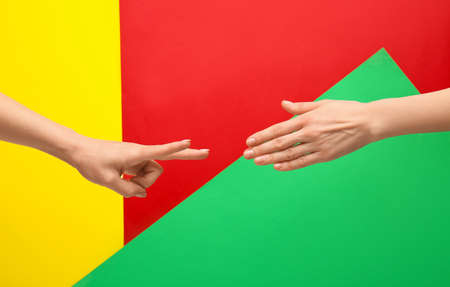 People playing roshambo game on color backgroundの写真素材