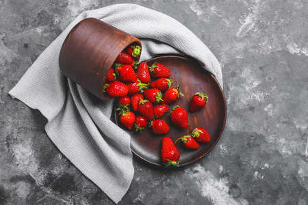 Sweet ripe strawberry scattered on table
