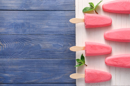 Board with tasty strawberry ice cream on tableの写真素材
