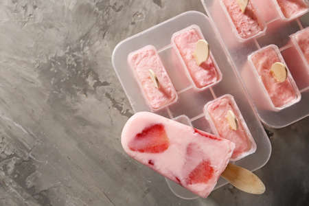 Tasty strawberry ice cream on grunge background