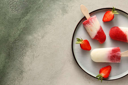 Plate with tasty strawberry ice cream on light background