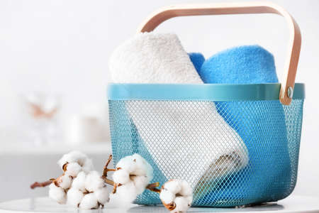Basket with cotton towels on table in bathroomの写真素材