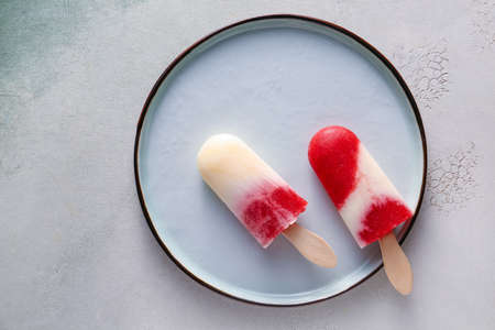 Plate with tasty strawberry ice cream on light backgroundの写真素材