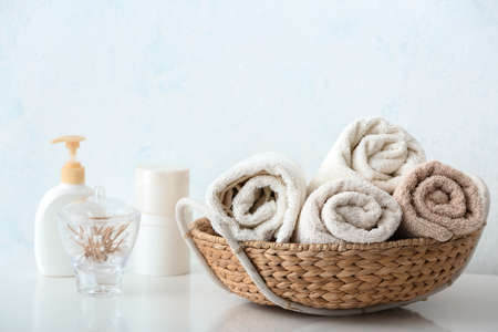 Basket with cotton towels on table in bathroomの写真素材