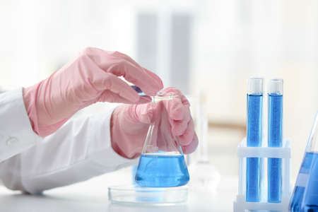 Scientist working with sample in laboratory